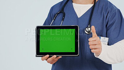 Buy stock photo Nurse, tablet and thumbs up with green screen in studio for advertising or Telehealth app. Person, hands or healthcare worker with like emoji or technology mockup for marketing on a white background