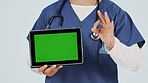 Nurse, tablet and hands with green screen for marketing app on a white studio background. Person, healthcare worker or showing mockup space with technology or OK sign for advertising or good review