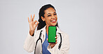 Doctor, phone and green screen or perfect sign for mockup approval, results or telehealth ux. Woman, studio portrait and smile by tech for motivation, ui review or ok feedback on white background 