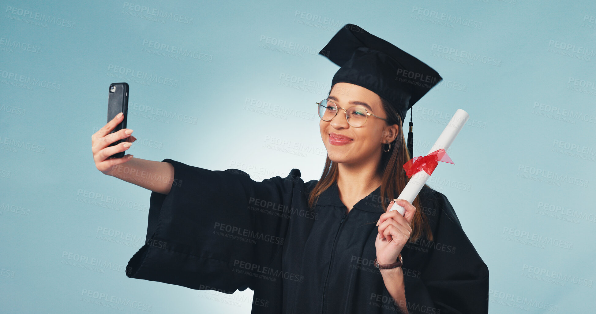 Buy stock photo Diploma, graduation and selfie of woman in studio for college success or social media post. Smile, graduate and person with certificate, profile picture or education milestone on blue background