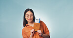 Pride, happy or woman in studio with passport, entry record or boarding pass in travel goals. Flight ticket, space or person with credentials, granted permit or tourist milestone on blue background.