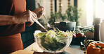 Salad, spoon and hands of woman in kitchen at house for nutrition, health or diet meal. Vegetables, glass bowl and female person with fresh ingredients for wellness, dinner or dish in apartment.