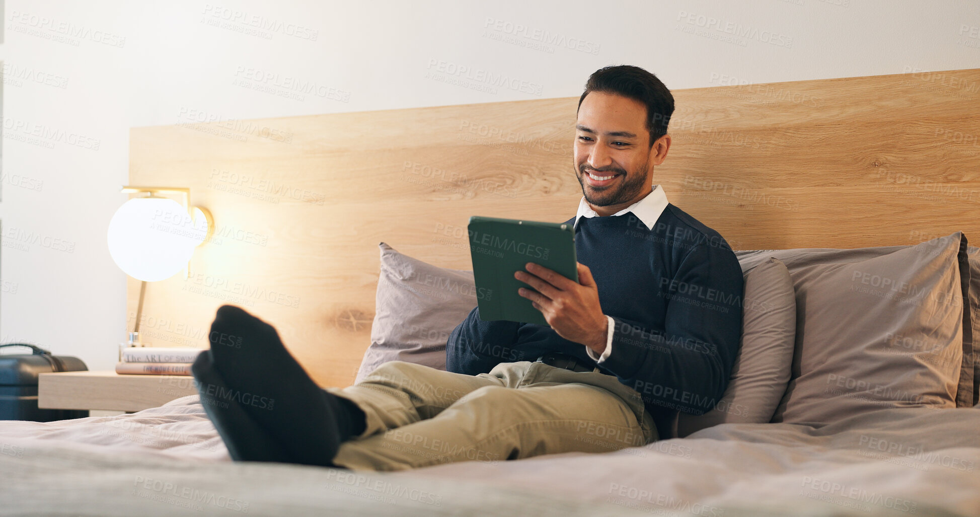 Buy stock photo Business, man and relax in hotel room with tablet, booking flight and website for work trip. Smile, male person and employee at motel with tech, departure schedule and reservation checkin for travel