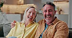 Couple, portrait and laughing on couch, home and bonding with partner on break or loyalty in lounge. Happy, mature people and connection on weekend, support and relationship commitment in house