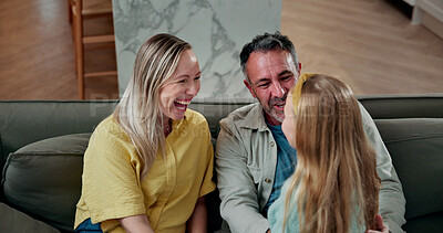 Buy stock photo Talk, child and parents with laugh on sofa for funny conversation, happy home and weekend break. Love, family and girl with chat in living room for relationship development, bonding and kid with joke