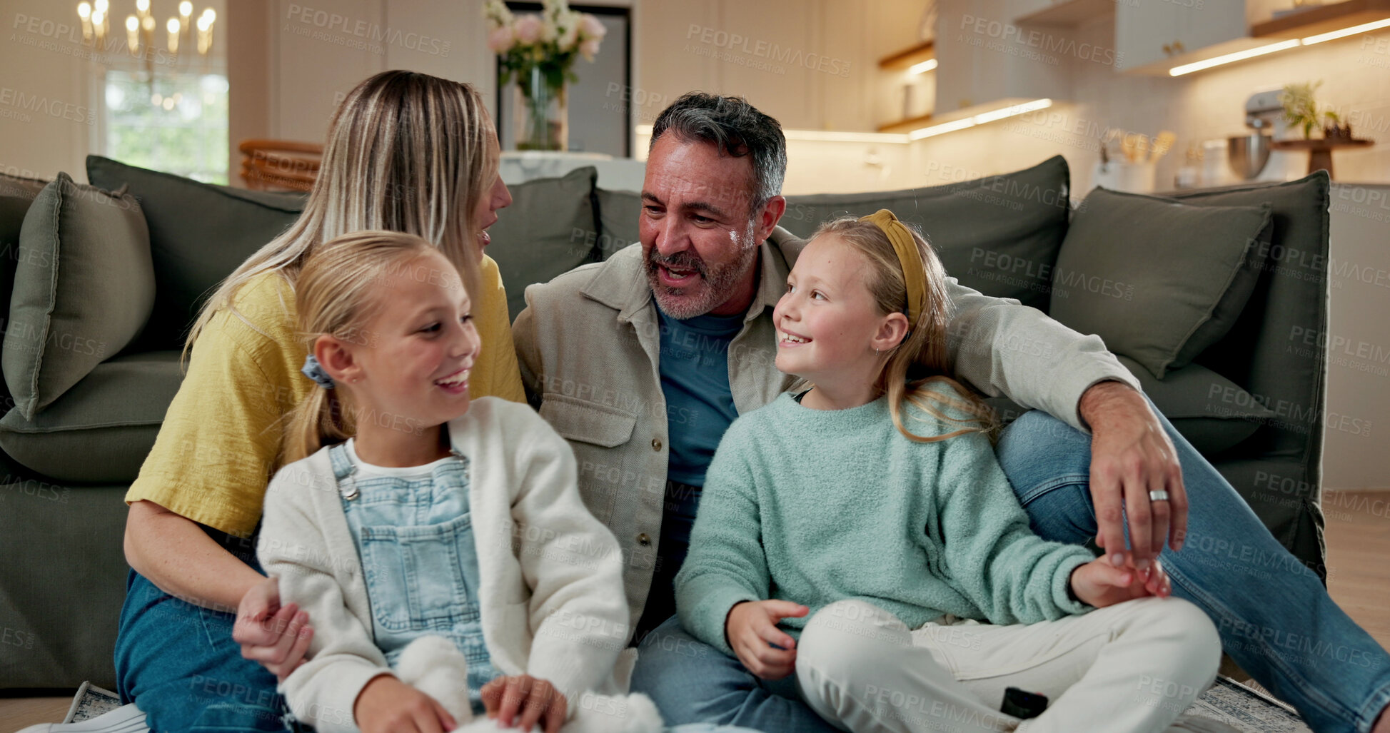 Buy stock photo Relax, children and parents with talk in house for bonding together, happy home and security. Love, family and girls with conversation on floor for relationship development, support and weekend break