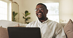 Laugh, remote work and black man with laptop in home, ebook manuscript or reading funny story. Computer, freelance author and person in living room with humor, review draft and publication update