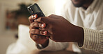 Texting, chat and hands in home with phone, online communication and post reaction on social media app. Digital, typing and man with technology, message update or networking on virtual platform.
