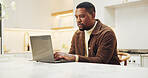 Typing, remote work and black man with laptop in kitchen, ebook manuscript or reading story. Computer, freelance author and serious person in home for editing article, review draft and publication