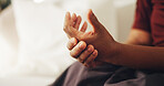 Fibromyalgia, hand and massage with person in home living room for joint pain, stiffness or swelling. Arthritis, disease or osteoporosis with elderly woman on sofa in apartment for health condition