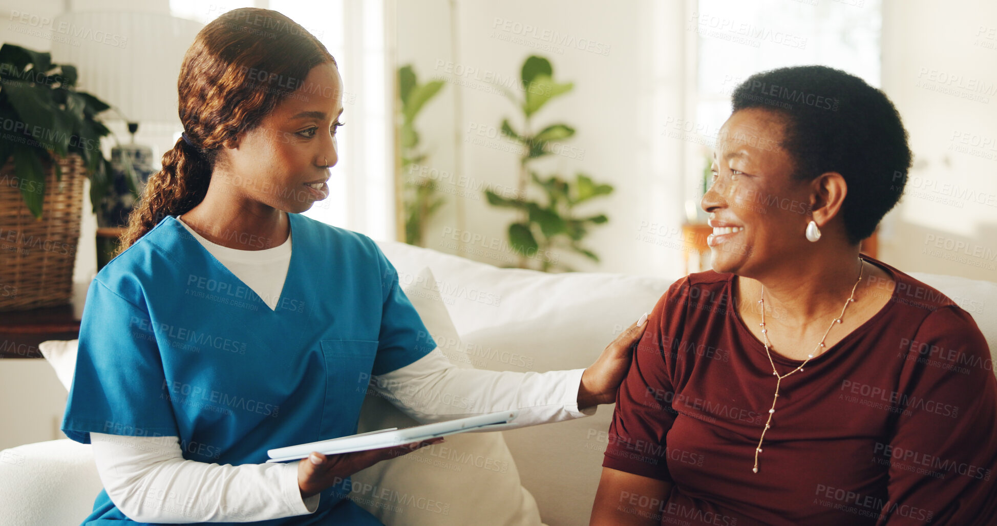 Buy stock photo Patient, smile and nurse in home with tablet, medical test results and conversation for diagnosis. Mature woman, black people and discussion on sofa with tech, healthcare support and wellness update