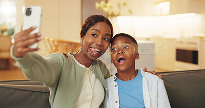 Buy stock photo Funny face, selfie and son with mom on sofa in home living room for bonding, memories or social media. Black family, love and tongue out with woman hugging boy child for photograph or profile picture