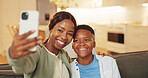 Selfie, smile and son with mom on sofa in home living room for bonding, memories or social media. Black family, love and security with woman hugging boy child for photograph or profile picture