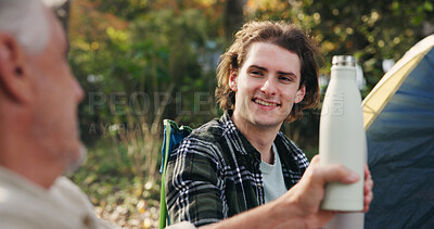 Buy stock photo Camping, drink and senior dad with adult son for travel or outdoor bonding together in nature. Elderly father, people or man with tent or cheers for vacation, holiday or weekend trip in wilderness