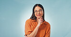 Studio, decision and woman with smile, thinking and planning for career path with ideas and daydream. Blue background, mockup space and happy person with glasses, choice reflection and future goals