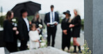 Funeral, sad and people in cemetery, blur and burial for death ceremony, emotions and grief. Family, graveyard and support for mourning, compassion and memorial service for loss, remember and empathy