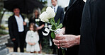 Funeral, rose and old woman in cemetery with hand, family grief and burial ceremony for final goodbye. Elderly person, flower and people in graveyard outdoor with memorial service, mourning or death.