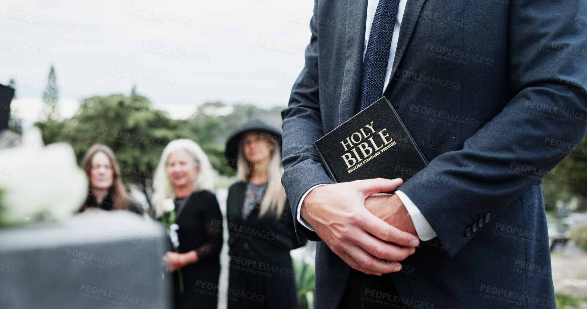 Buy stock photo Person, hands and pastor with holy bible for funeral, memorial service or worship of god. Family, people or priest with book, religion or faith at graveyard or cemetery for death or burial ceremony