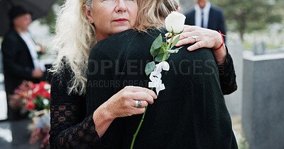 Buy stock photo Woman, hug and funeral with rose for condolences, respect or mourning death together in cemetery. Female person, family and embrace with empathy or grief for farewell, burial or ceremony in graveyard