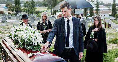 Buy stock photo Man, funeral and rose with offering on coffin for grief or mourning death together in graveyard. Male person, sad family and empathy with flower for farewell, burial or paying respect in cemetery