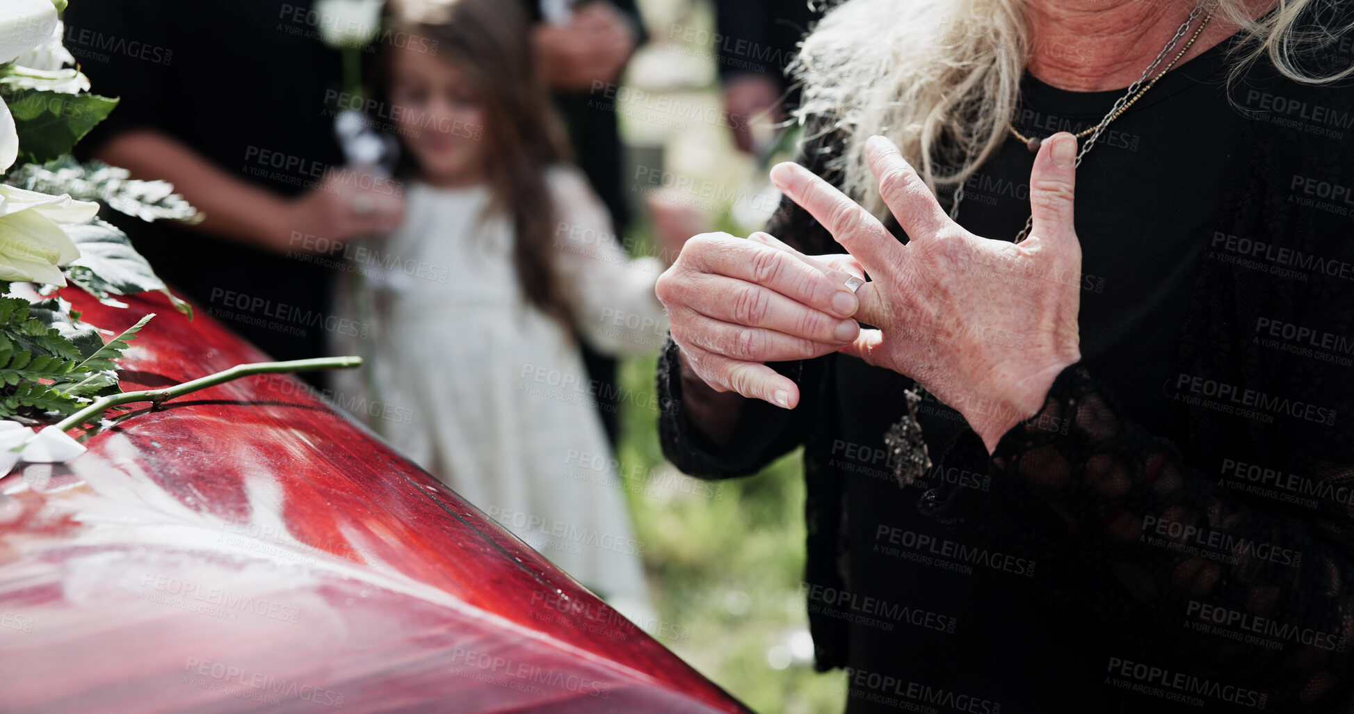Buy stock photo Hands, coffin and woman in graveyard, widow and mourning for grief, compassion and empathy. Casket, remove ring and people in cemetery, memorial service and support for death ceremony, loss or burial
