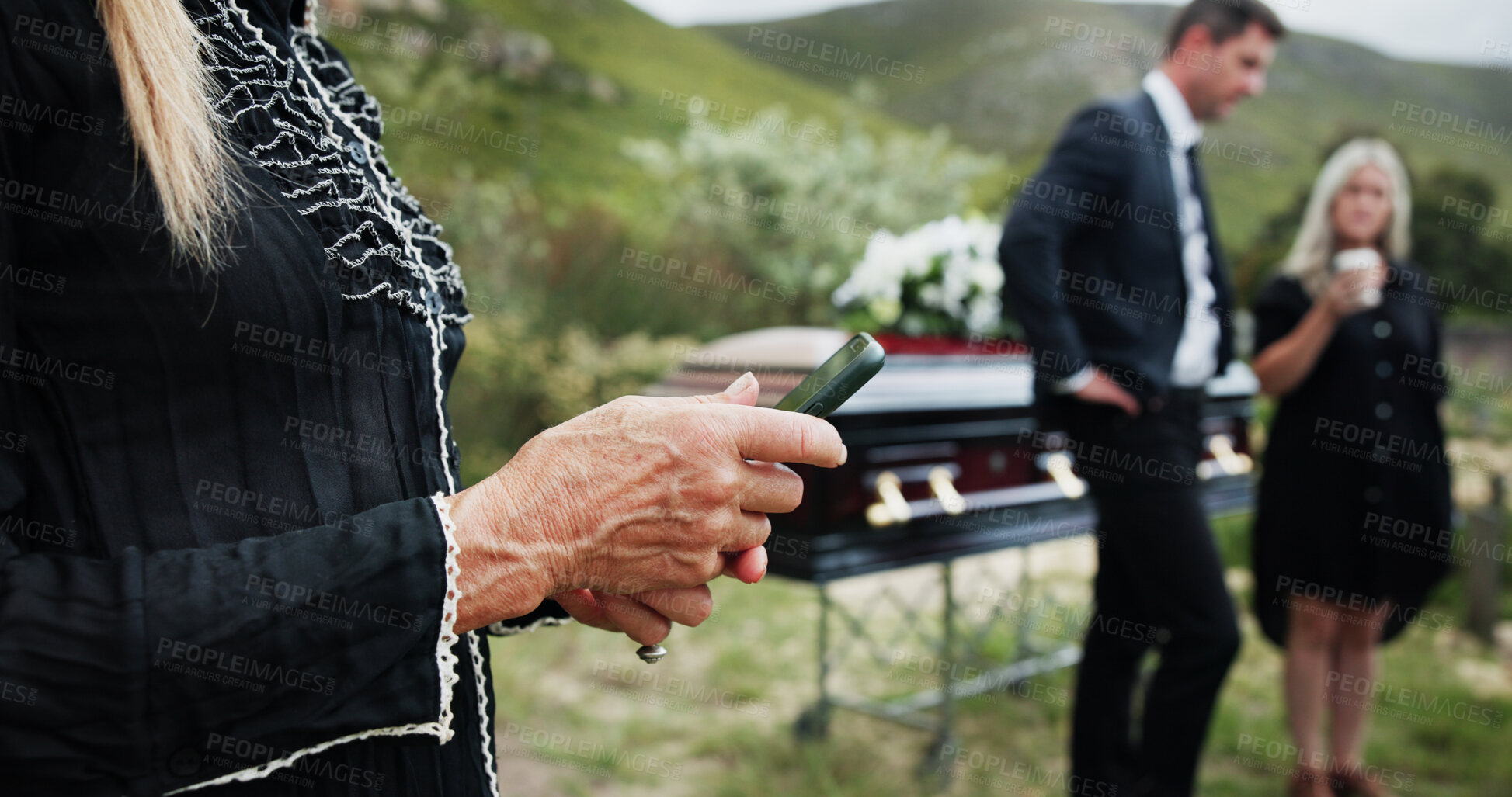 Buy stock photo Funeral, hands and old woman in graveyard, smartphone for online chatting or post for memory. Family, loss or mature person in cemetery, cellphone or message to contact, communication or social media