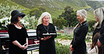 Funeral, old women and pastor with bible at graveyard, religion and memorial service with community. Christian, faith and elderly person with scripture for burial, prayer and ceremony with family