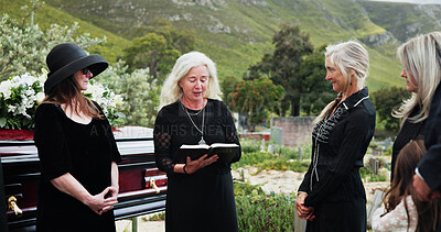 Buy stock photo Funeral, old women and pastor with bible at graveyard, religion and memorial service with community. Christian, faith and elderly person with scripture for burial, prayer and ceremony with family