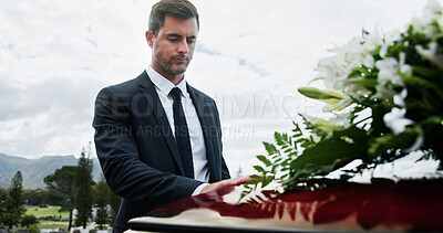 Buy stock photo Sad, man and funeral in graveyard with coffin, grief and bereavement for burial ceremony of loved one. Person, sorrow and mourning in cemetery outdoor with casket, final goodbye and memorial service.