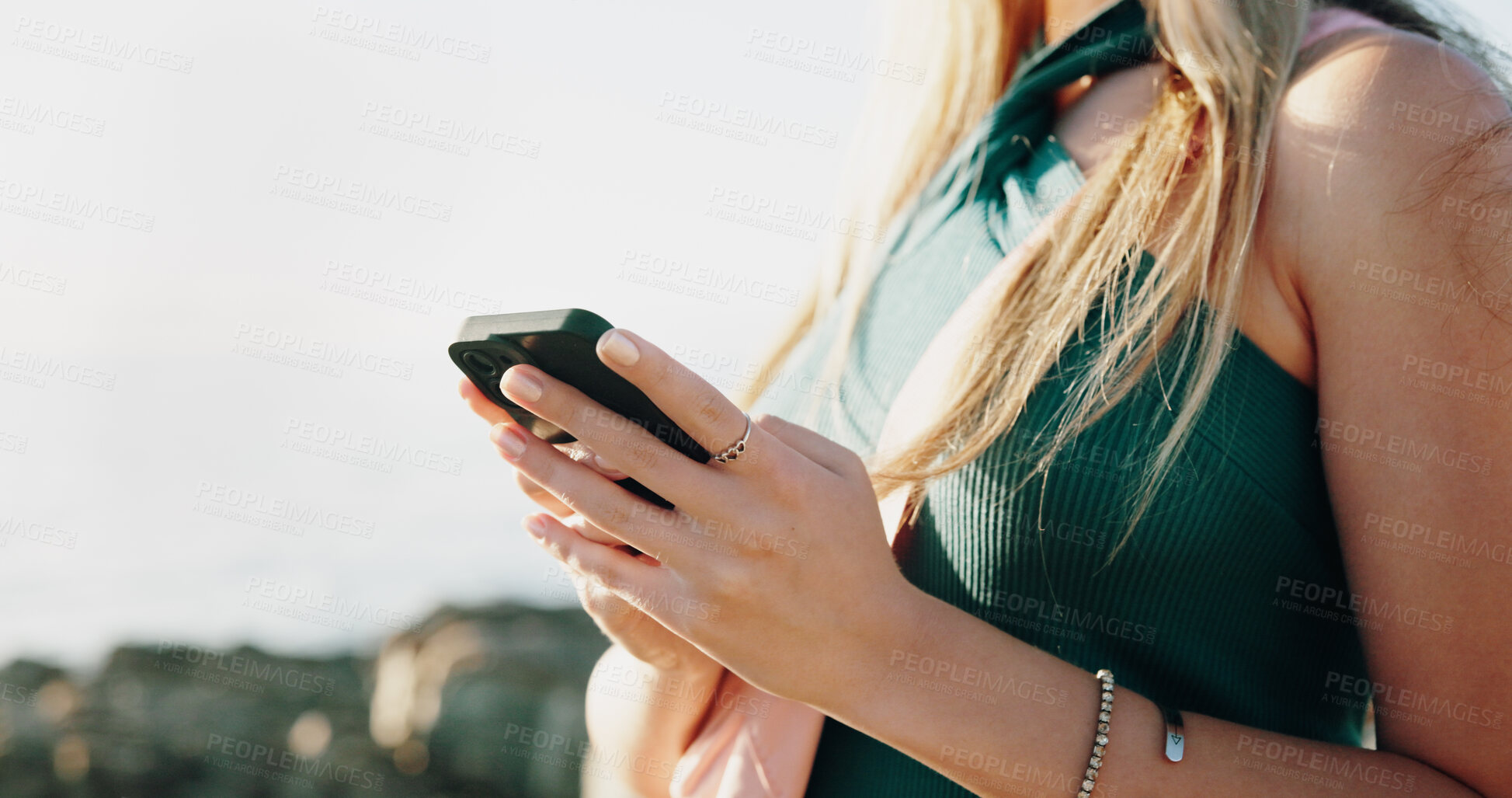 Buy stock photo Hands, typing and phone with woman at beach for travel blogger, social media and summer vacation post. Communication, online holiday guide and contact with person outdoor for tourism and chat