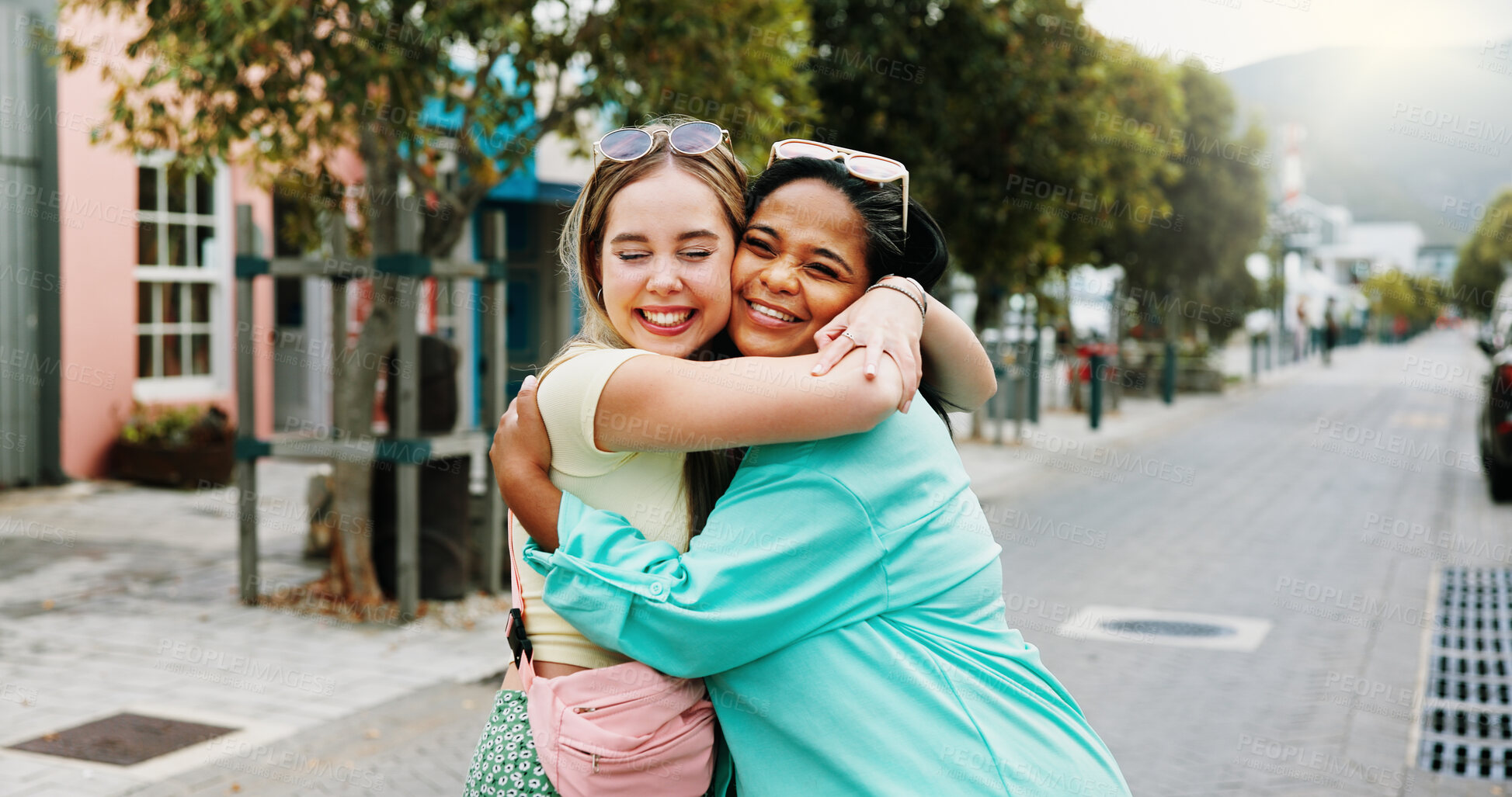Buy stock photo Women, hug and bonding in city for reunion, excited and friends with smile for relationship or care. Outdoor, together and interracial people with affection for support, happy and embrace on street