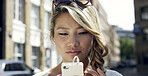 Earphones, outdoor and Asian woman in city with phone, social media post and listen to music playlist. Person, audio tech and reading online news in urban town with mobile app, podcast and website.