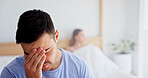 Anxiety, headache and man in bedroom of home for argument, disagreement or relationship stress. Conflict, fight and frustration with couple on bed in apartment for anger, fail or marriage mistake