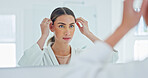 Woman, mirror and grooming with hair in bathroom for skincare, beauty or cosmetics in home. Female person, reflection or morning routine with hairstyle in robe for styling or appearance in house