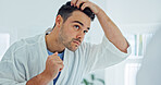 Man, mirror or grooming with hair in bathroom for beauty, skincare or morning routine in home. Male person, reflection or checking hairstyle with appearance for facial cosmetics or styling in house