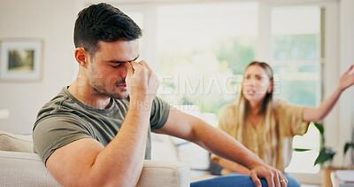 Buy stock photo Stress, argument and man on sofa in home with conflict, breakup or cheating problem in relationship. Couple, disagreement and male person with fighting, divorce or affair drama in marriage at house.