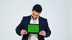 Green screen, space and tablet with business man in studio for information, offer or promotion. Display, mockup and technology with happy employee on white background for announcement or review