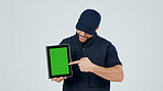 Man, tablet and pointing at green screen for marketing, promotional info or app for service in studio. Employee, mockup space and advertising presentation with UI, tech and display on background