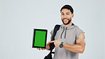 Green screen, tablet and portrait of bodybuilder in studio with space for gym subscription. Happy, man and athlete pointing to digital technology for fitness app, website or blog by white background.