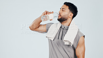 Buy stock photo Fitness, man and drinking water in studio with hydration break, exercise and wellness for bodybuilder. Space, person or athlete with beverage for electrolytes, rest and recovery on white background.