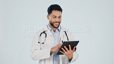 Buy stock photo Tablet, man and doctor in studio with research for medical diagnosis, treatment or telehealth. Space, technology and male healthcare worker on app for clinic consultation booking by white background.