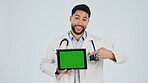 Doctor, portrait or happy man pointing with tablet or green screen in studio for Telehealth app. Male person, healthcare worker or technology with mockup space for advertising on a white background