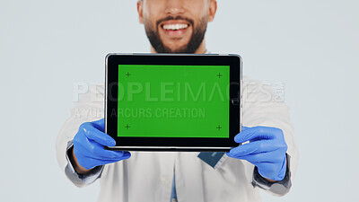 Buy stock photo Doctor, hands or tablet with green screen in studio for advertising, presentation or Telehealth app. Male person, healthcare worker or smile with technology or mockup space on a white background