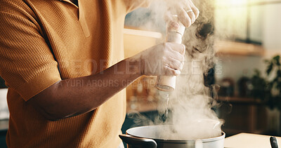 Buy stock photo Cooking, pepper and man in kitchen with pot, recipe and meal prep for dinner, lunch or supper. Home, hands and person by stove with ingredients, seasoning and heat for nutrition, flavor and cuisine
