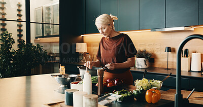 Buy stock photo Cooking, vegetables and mature woman in kitchen with pot, recipe and meal prep for dinner. Home, lunch and person by stove with ingredients, culinary skills and food for nutrition, health and cuisine