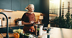 Cooking, stove and senior woman in kitchen with pot, recipe and meal prep for dinner, lunch or supper. Home, thinking and person with ingredients, vegetables and idea for nutrition, health or cuisine