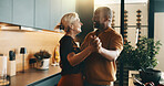 Happy, dance and couple in kitchen for cooking, bonding and love with music, song and meal prep. Interracial, marriage and mature man and woman with radio for dinner, lunch and help with cuisine