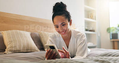 Buy stock photo Texting, online and happy woman with phone in bedroom, scroll and communication with contact on web. Typing, message and person with mobile for chat, resting or browsing social media app in home