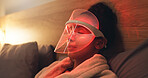 Red light, mask and woman in bedroom with skincare for beauty, wellness and collagen production. Health, relax and person in bed with LED phototherapy for dermatology or facial treatment in home