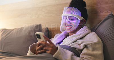 Buy stock photo Blue light, skincare and woman with phone in bedroom for beauty, wellness or antibacterial facial. Health, relax and person in bed with LED phototherapy tech for dermatology or mask treatment in home